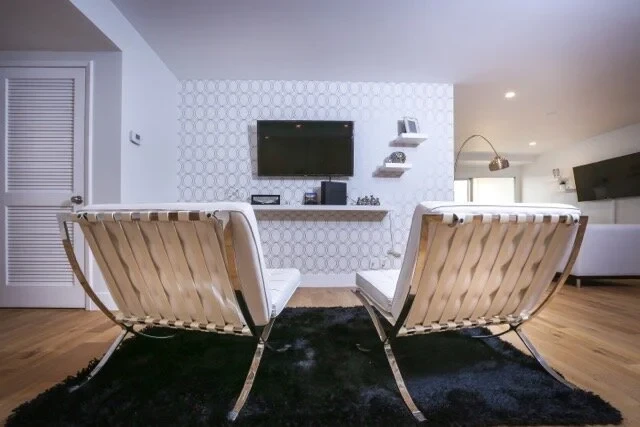 Living room lounge with modern furniture and TV wall